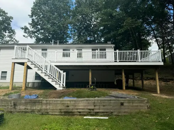Elevated composite deck with stairs leading to yard in Bellingham, MA