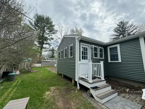 Custom composite entry deck and stairs with white vinyl railings in Hopkinton, MA